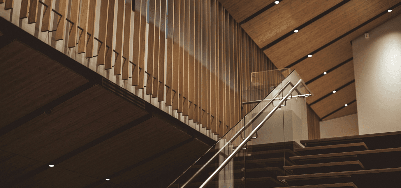 Free Framer Template - A wooden staircase with a sloped roof and warm lighting highlights the interior design of the space.