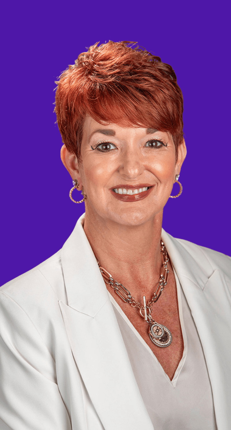 Profile portrait of a man in a white shirt against a light background