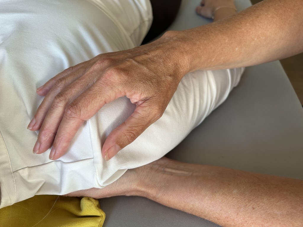 a close up of a person laying in a bed with a towel