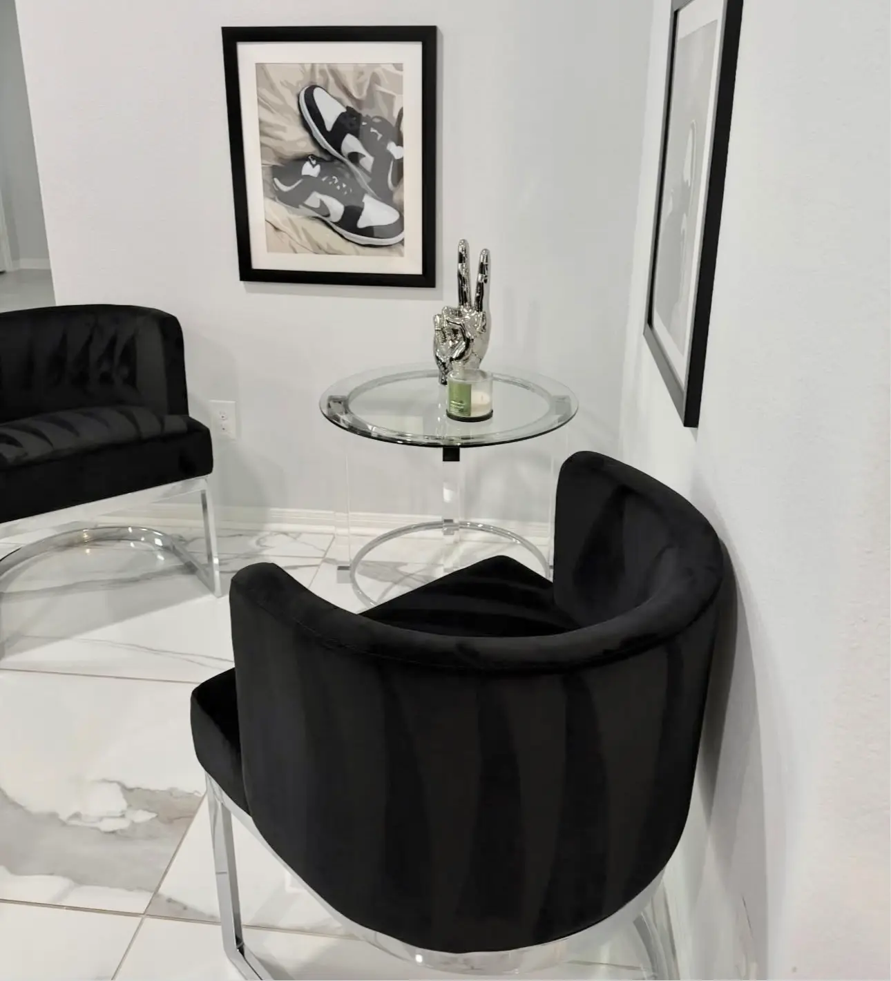 Tidy and dusted modern lounge area featuring clean black velvet chairs and a spotless glass table, representing high-end residential cleaning.