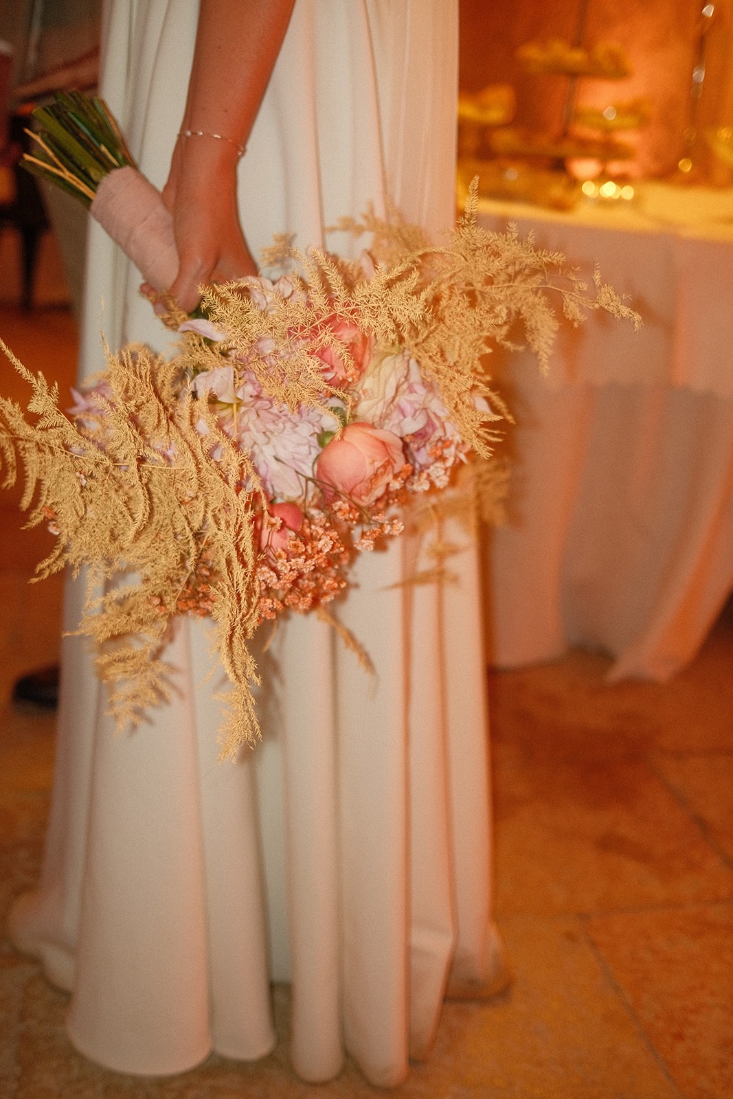 Bride holding a bouquet of flowers in a dining room