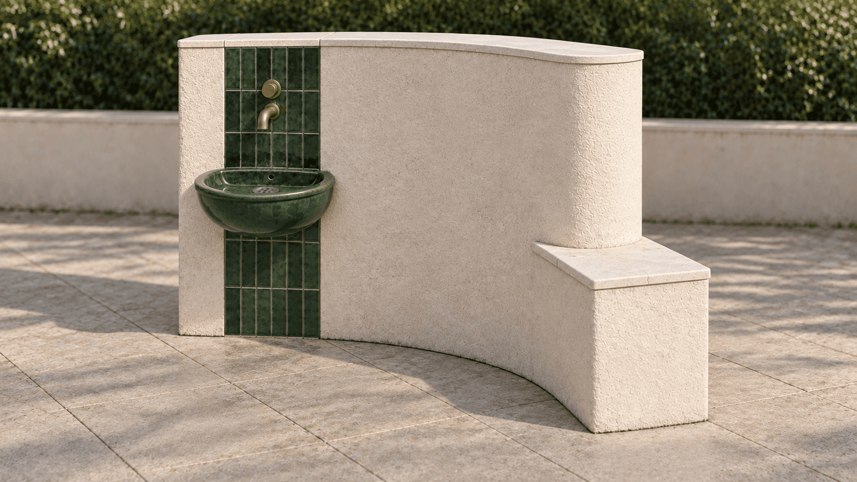Alternate view of the curved mineral wall, green ceramic water point and low stone-topped ledge.