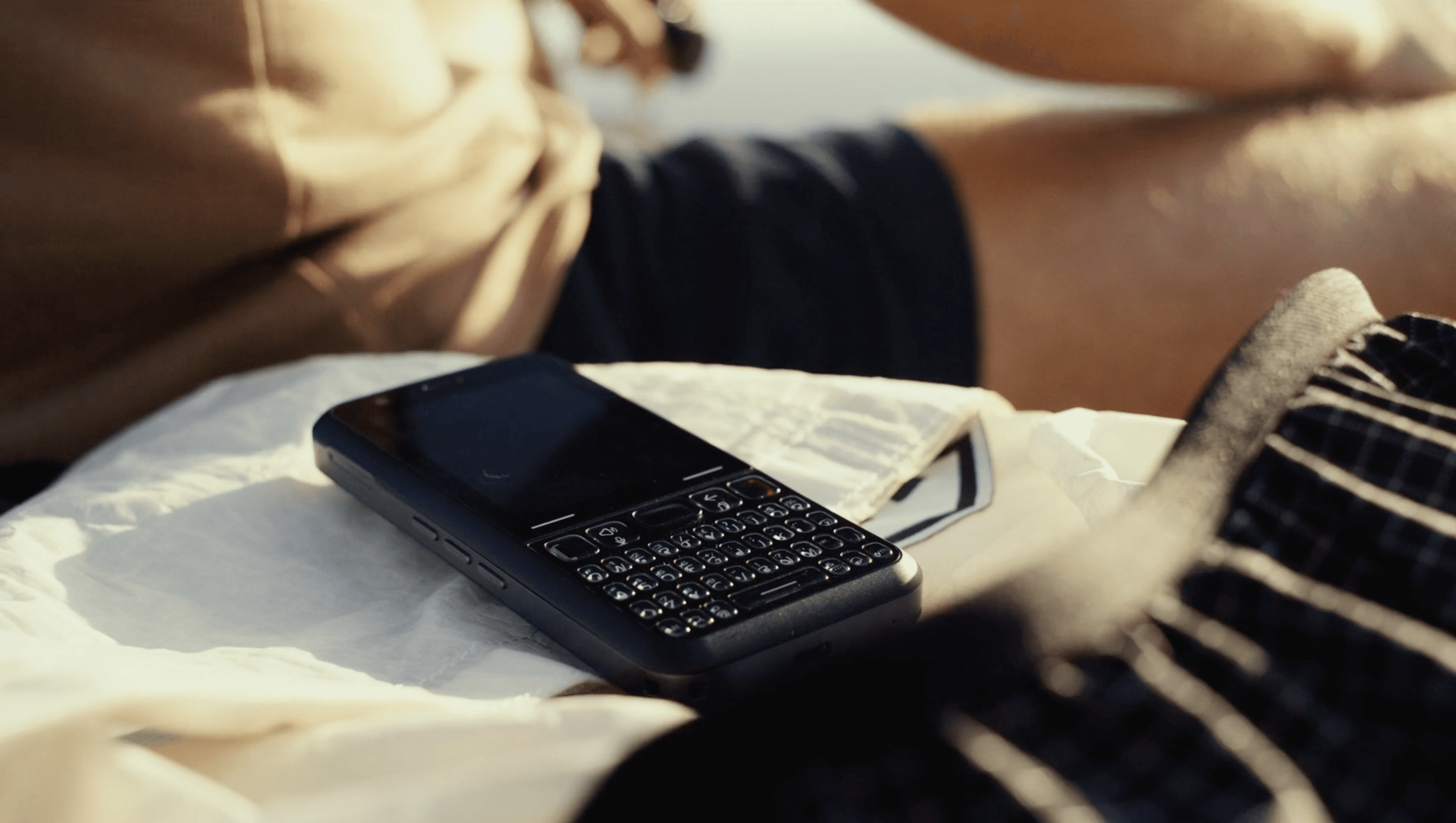 Bright neon signs illuminate a busy city street at night.