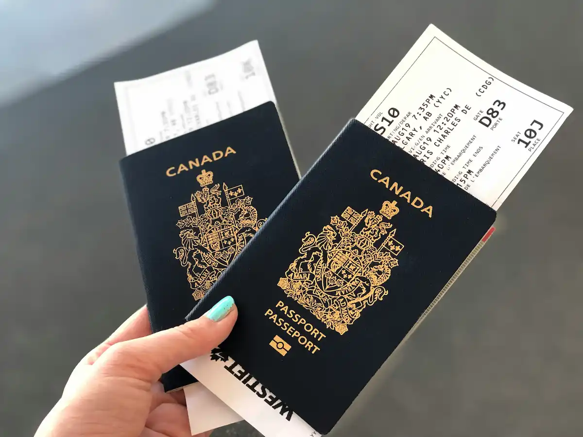 Photo of two Canada passports with boarding passes inside.