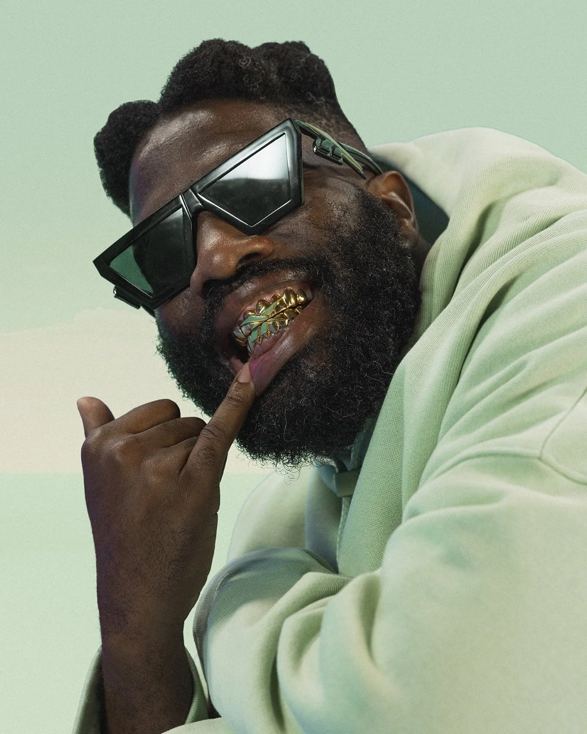 A fluffy gray rabbit rests on a floral chair.