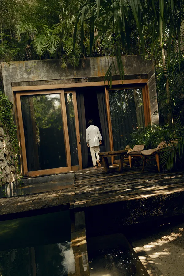 Pool area surrounded by jungle ambiance with loungers and tranquility at Be Tulum.