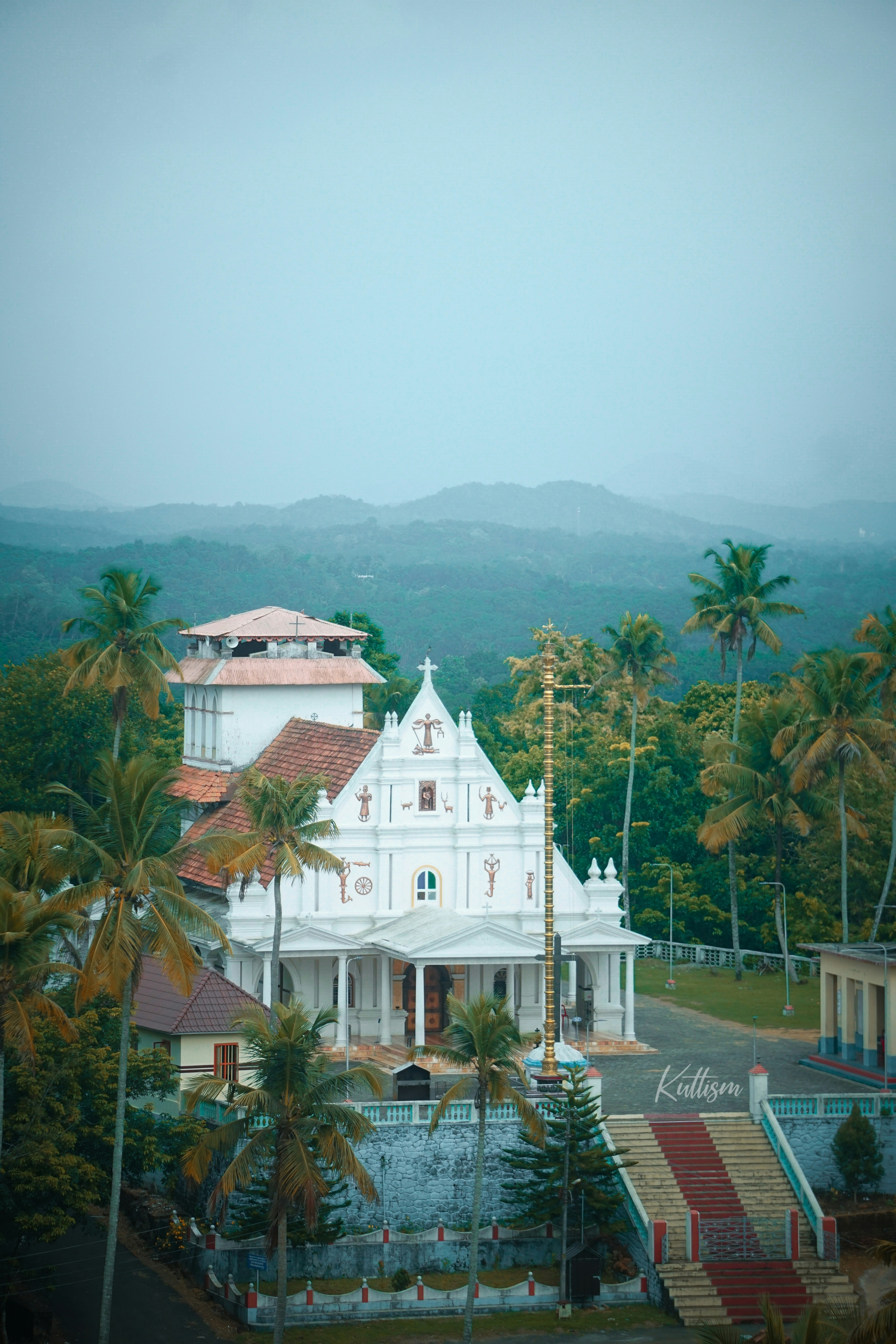 a large white building surrounded by palm trees
