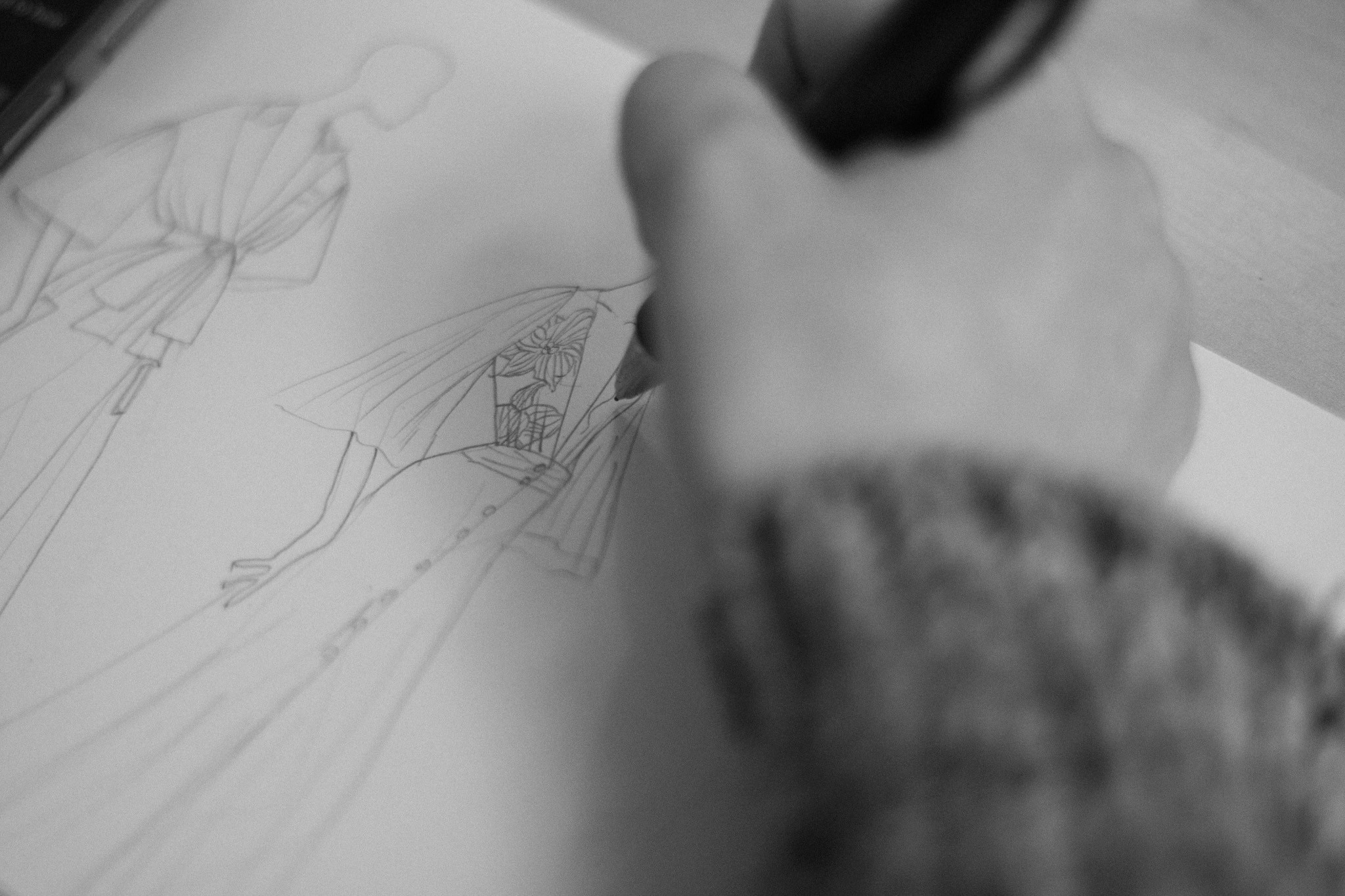 Photo of a wedding dress designer sketching wedding gowns