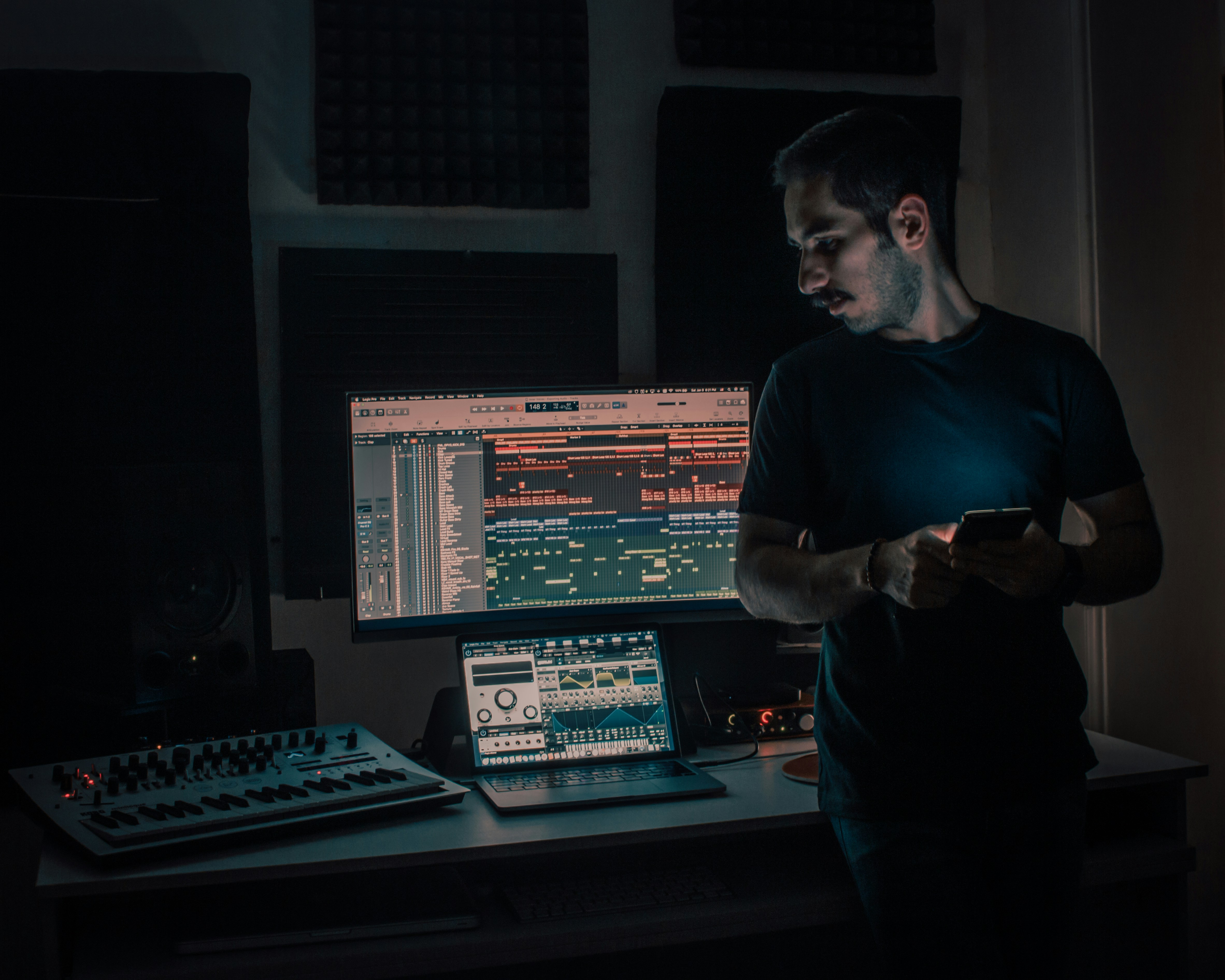 man standing beside his audio setup - sampling in music examples