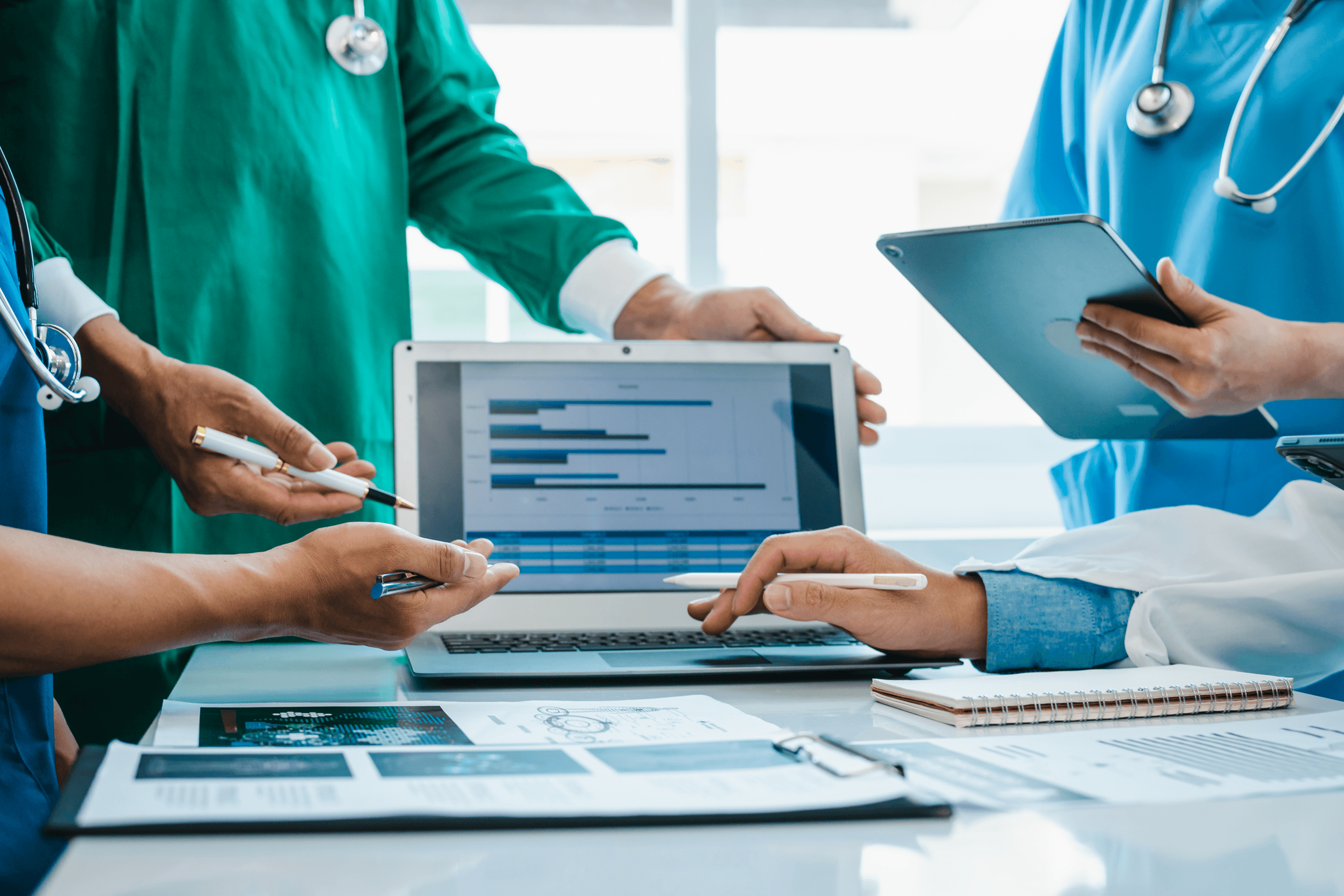 Healthcare team reviewing a patient portal dashboard on a laptop and tablet, illustrating portal features, system architecture, and EHR integration planning.