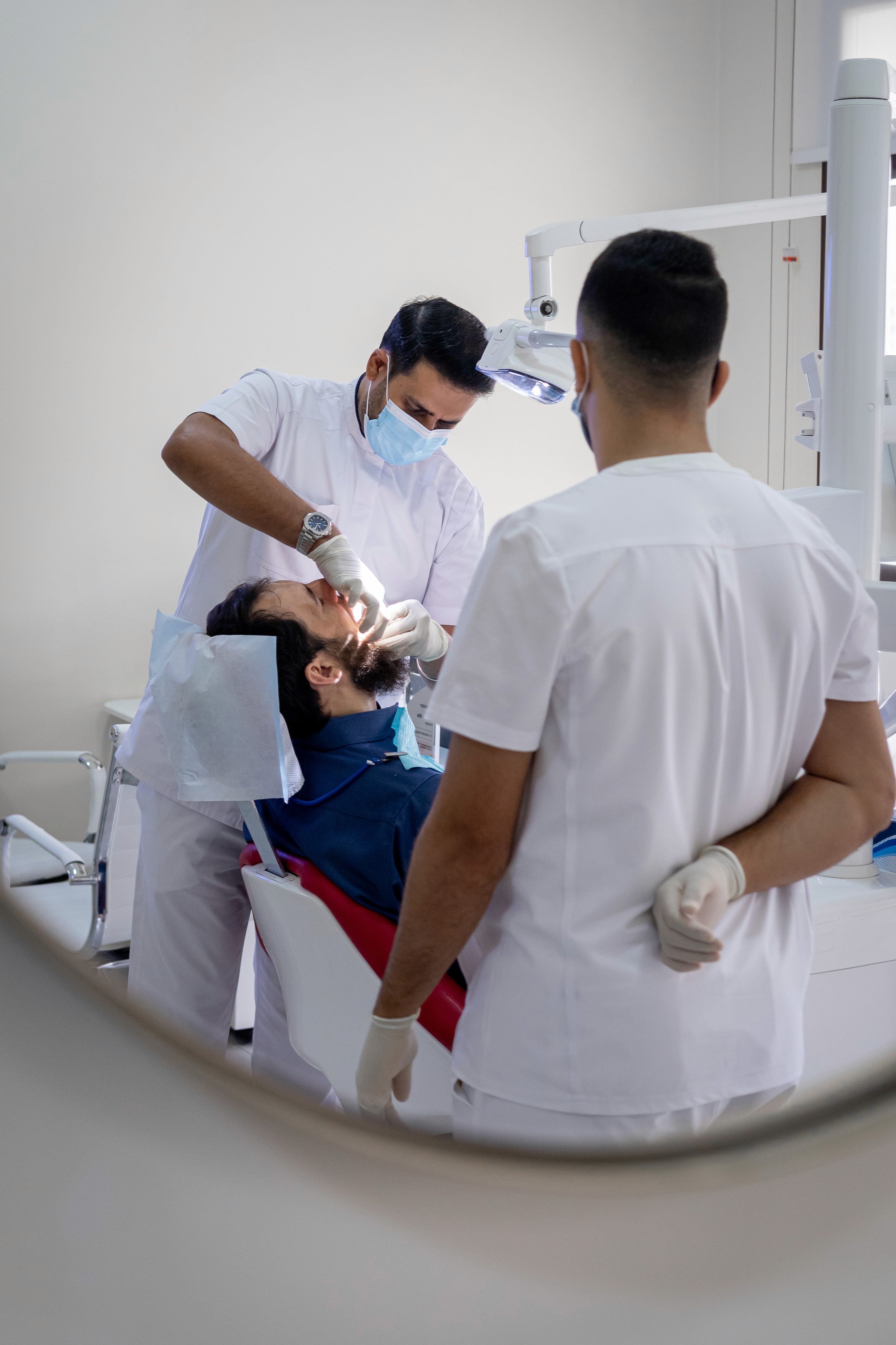 Dentist performing wisdom tooth extraction in clinic