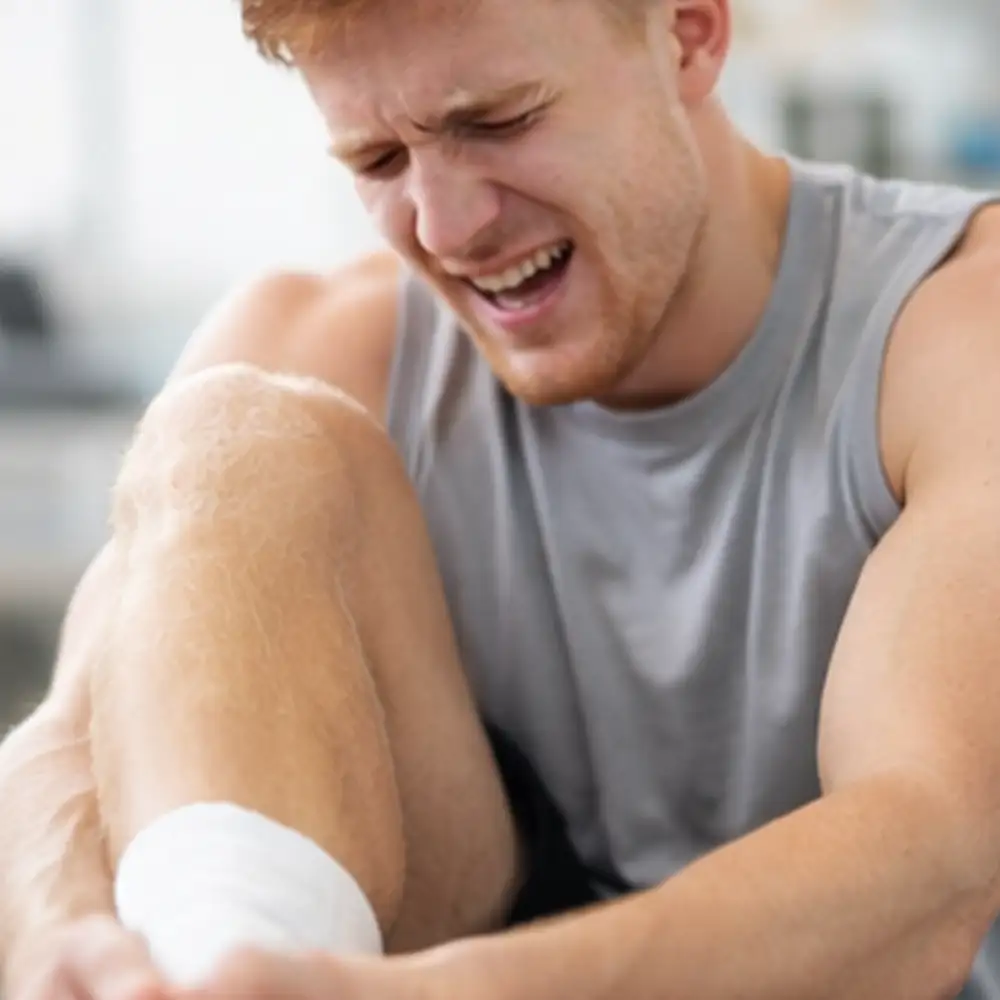 Chiropractor examining a male patient with shoulder pain during a treatment assessment in Draper, Utah