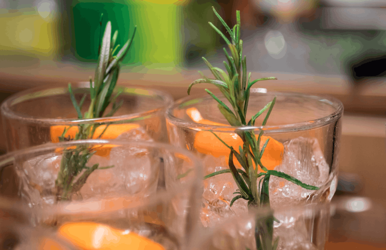 Some orange flowers in vases with water.