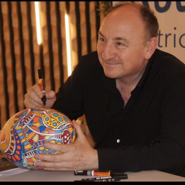 a blurry photo of a person standing in front of a wall