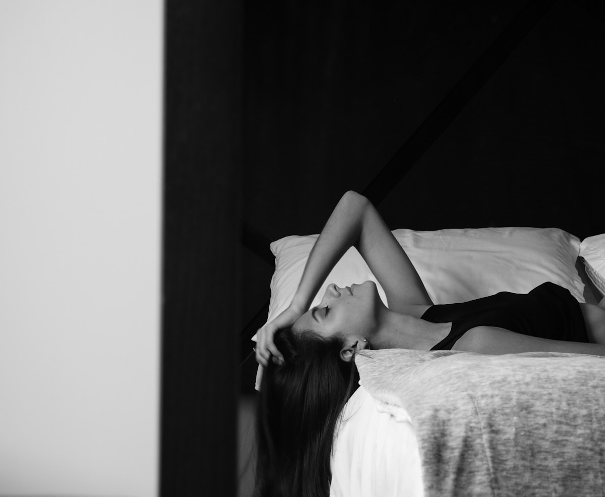 Woman in white dress lying on bed — editorial culture image 7 for "Weekend Rituals"