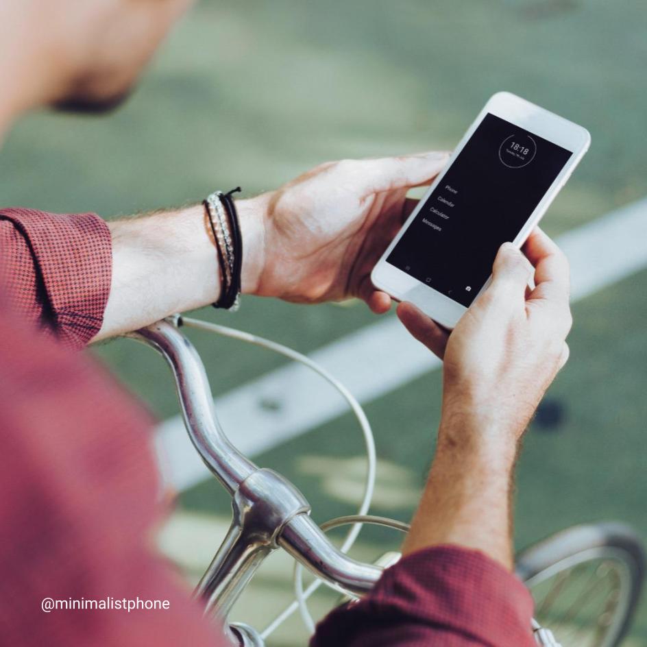 Person using the minimalist phone app while sitting on their bike