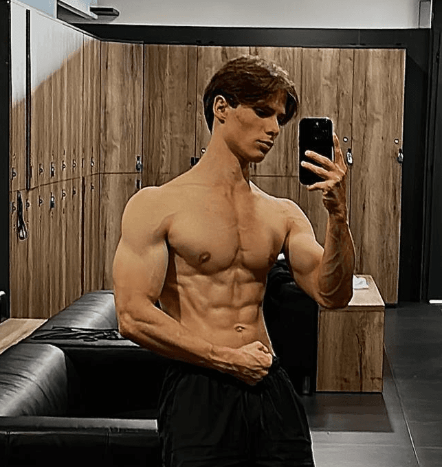 greyscale photo of woman in bralette inside room