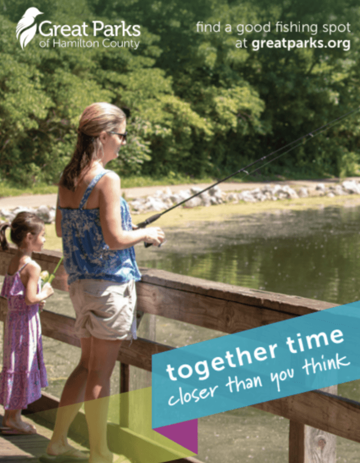 A mother and daughter stand on a pier, fishing in a lake
