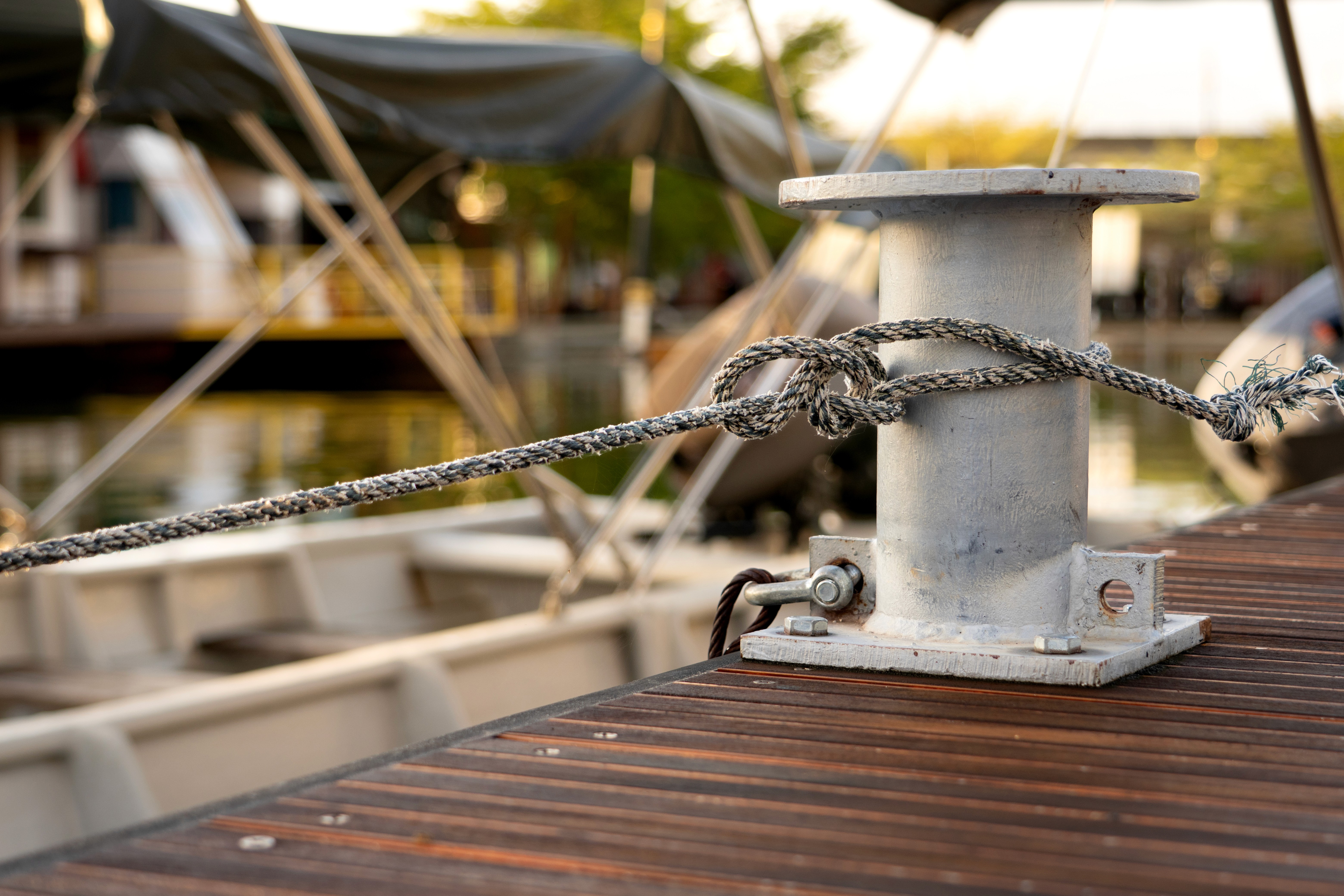 Single rope tied to one dock bollard: a referral-only pipeline is one frayed line away from collapse, just like a service business with no marketing system