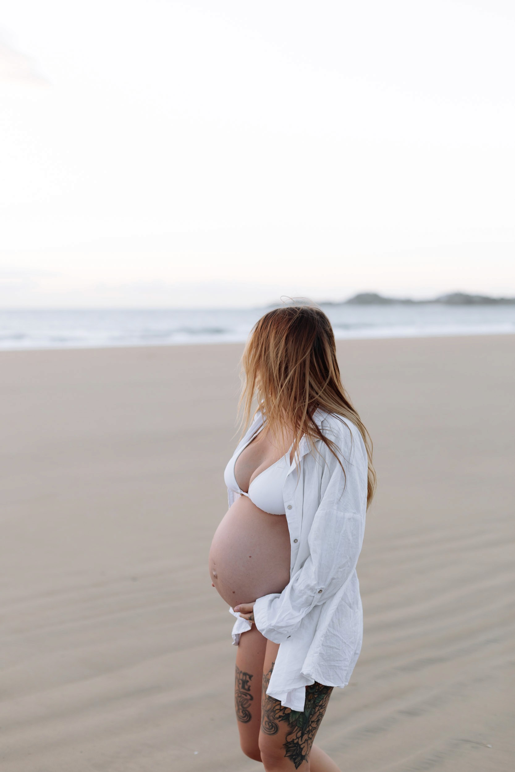 Expecting mother at sunrise beach maternity photoshoot in Mackay