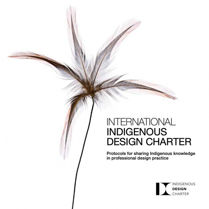 Modern home office setup with a monitor, ergonomic chair, keyboard, and indoor plants near a window with blinds.