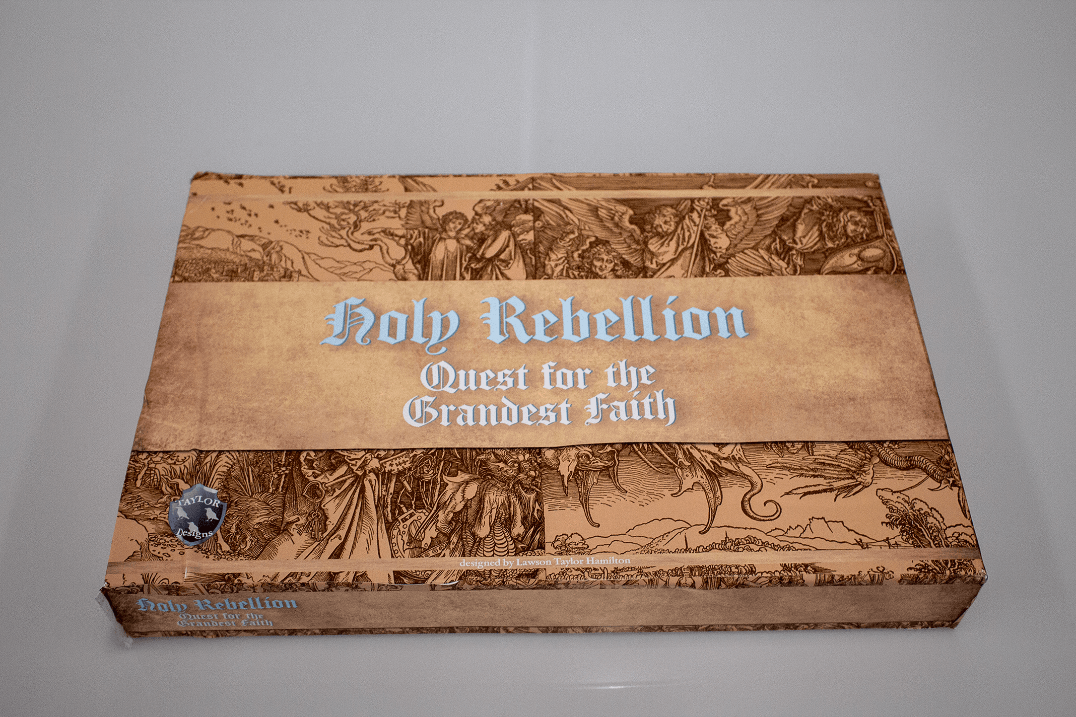 Board game box mockup with aged parchment texture, medieval woodcut illustrations, and blackletter typography
