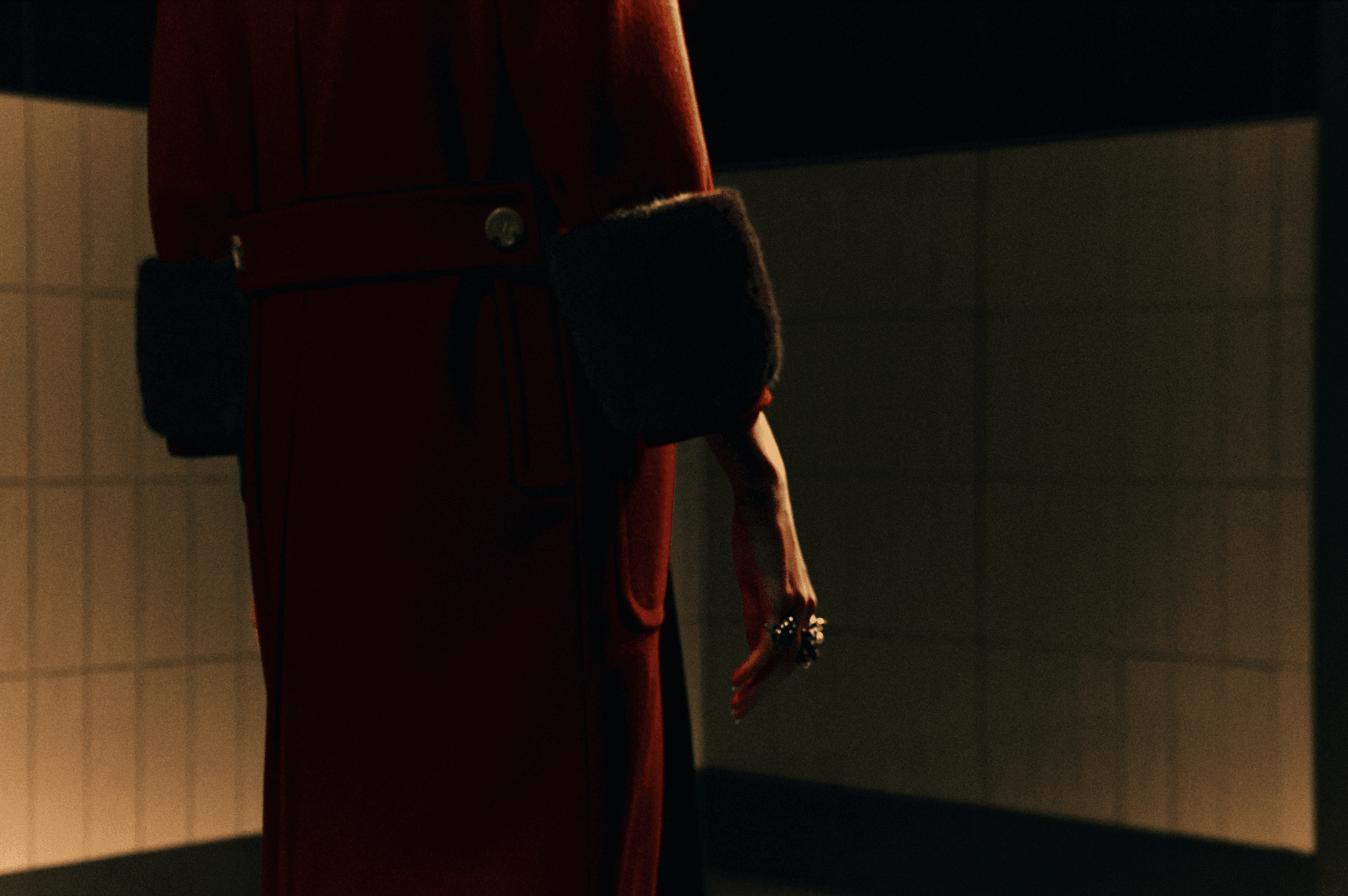 A fast black sports car races down the highway.