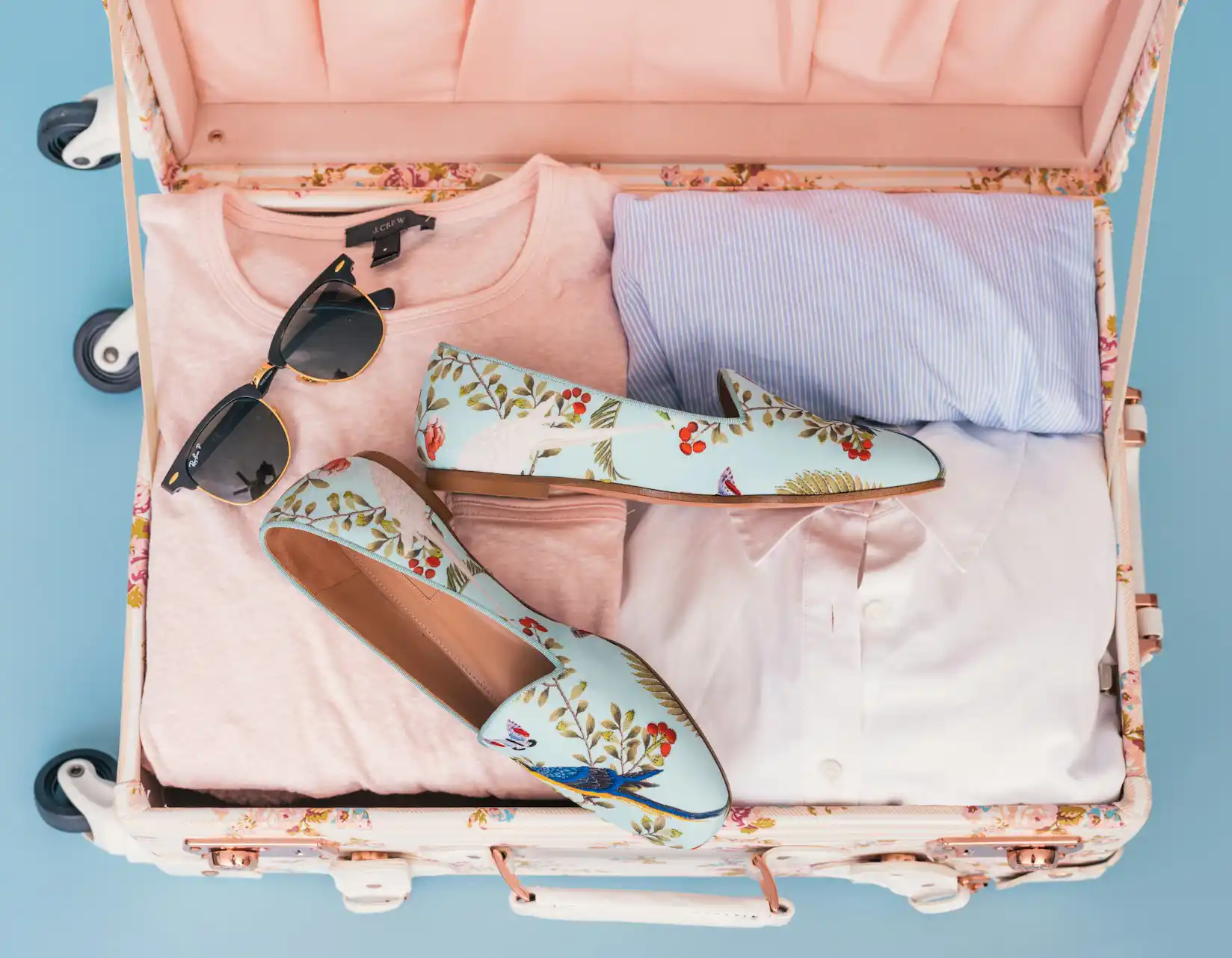 pastel suitcase packed with girly things