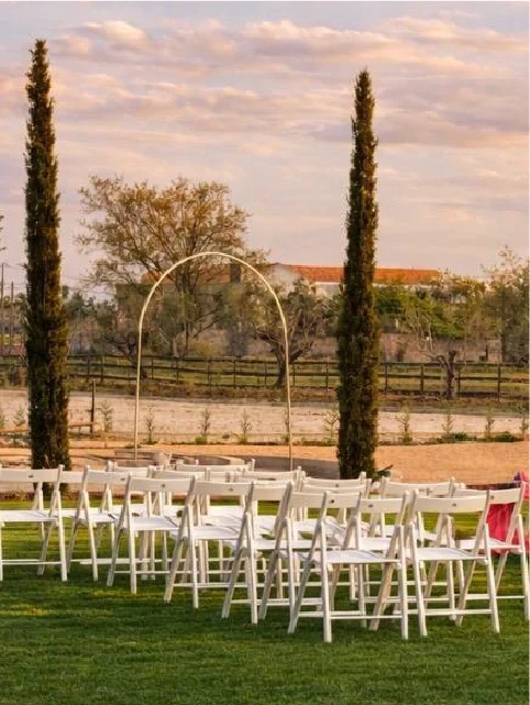 A hotel bed with pillows and ambient lighting.