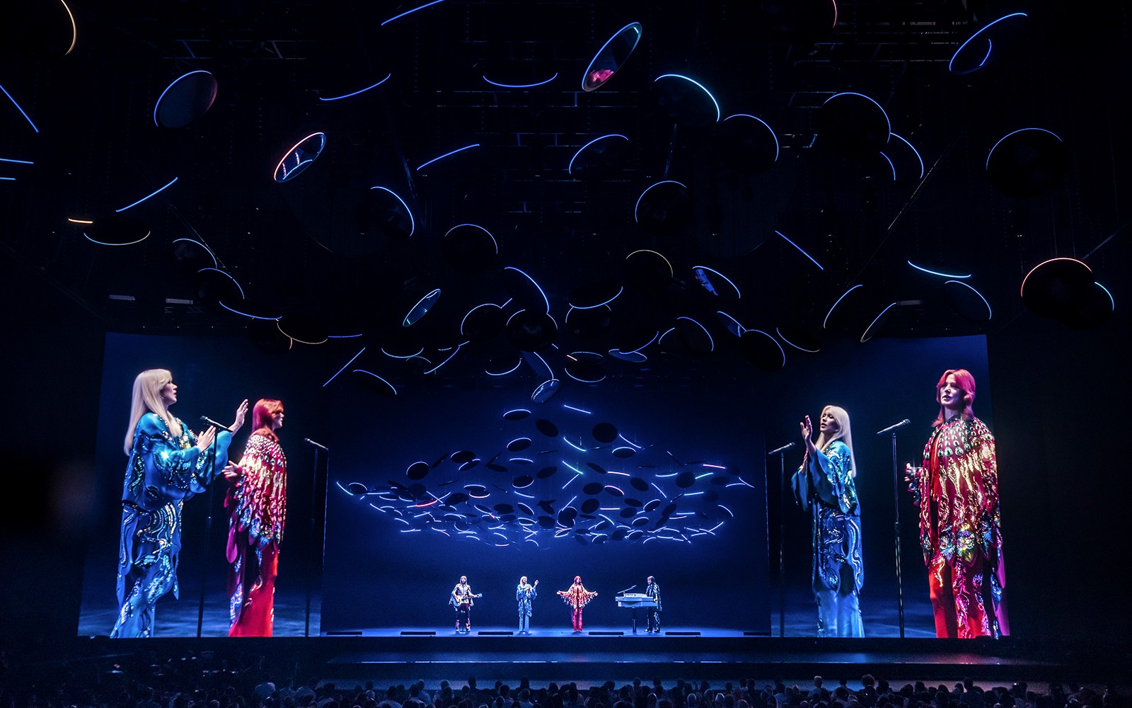 ABBA Voyage concert stage with holographic performers and dynamic lighting in London.