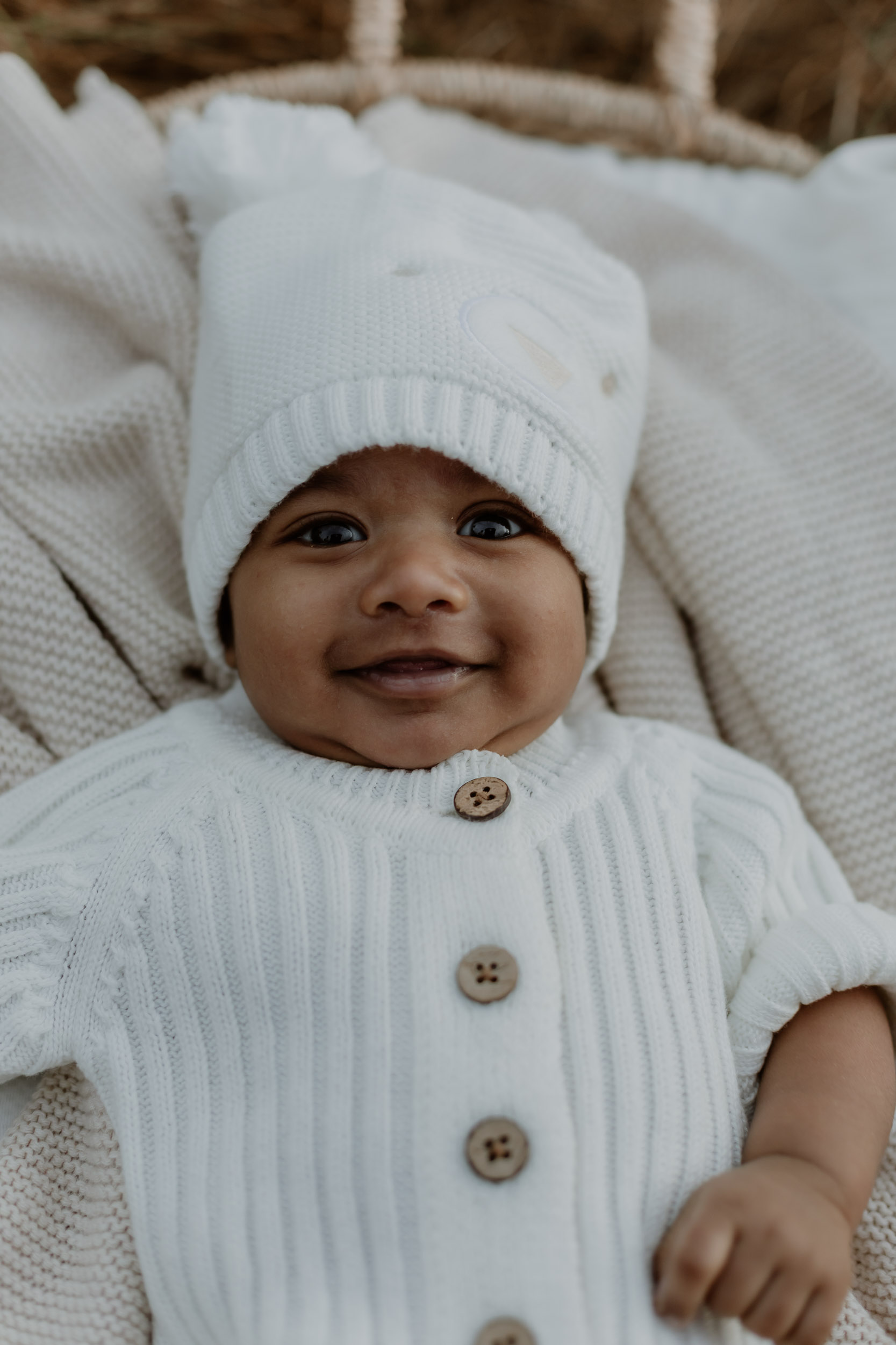 Newborn baby laying in basket in outdoor newborn photoshoot Mackay