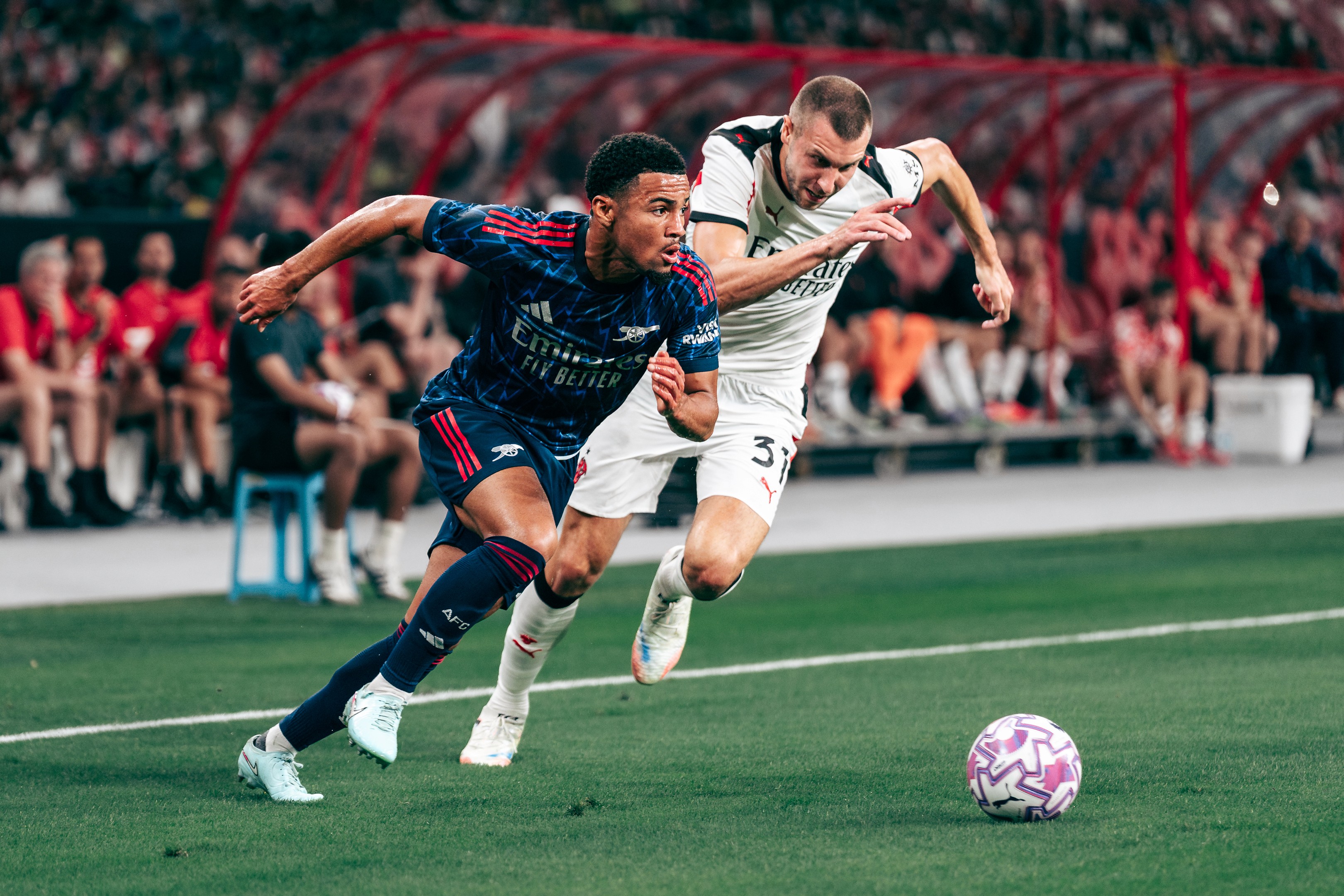 Ethan Nwaneri challenges with Strahinja Pavlovic for the ball during a match between Arsenal and A.C. Milan at the National Stadium in Singapore for the Singapore Festival of Football 2025