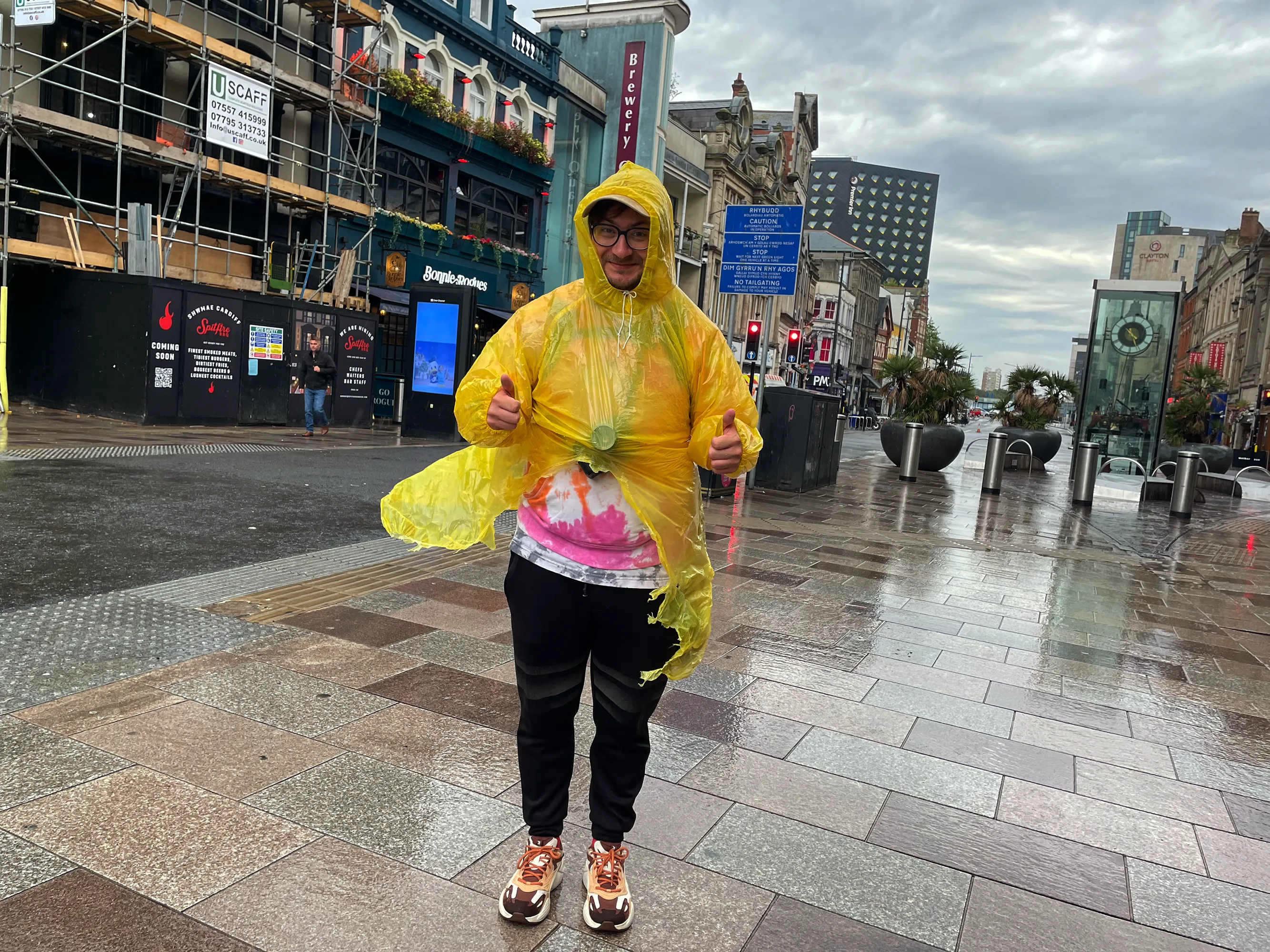 Martin Paseka standing in rain poncho on street