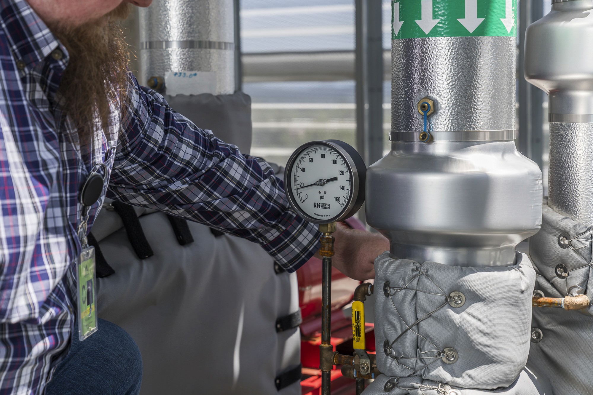 Technician performing predictive maintenance using building monitoring data