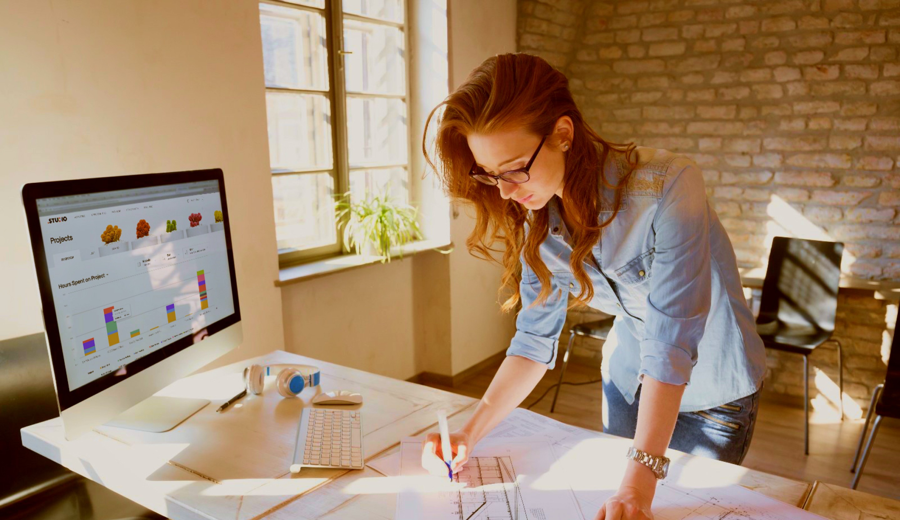 woman sitting while working on laptop and smiling 