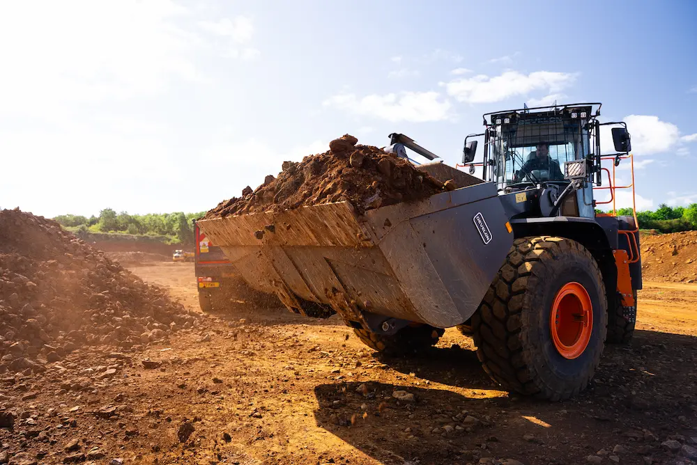 Operated articulated dumper moving earth on UK construction site