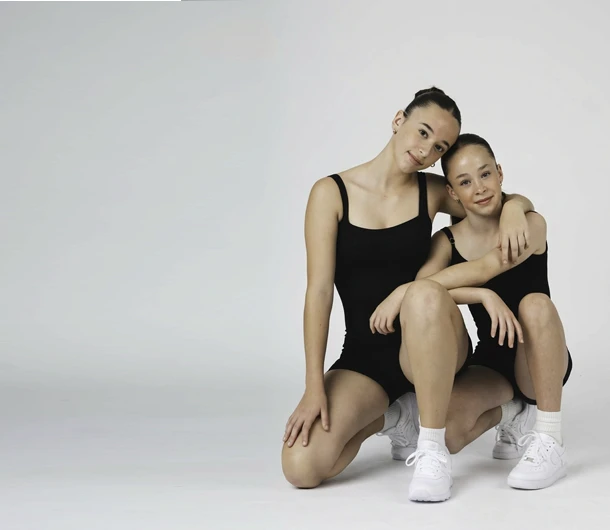 Sibling students in uniform at the studio