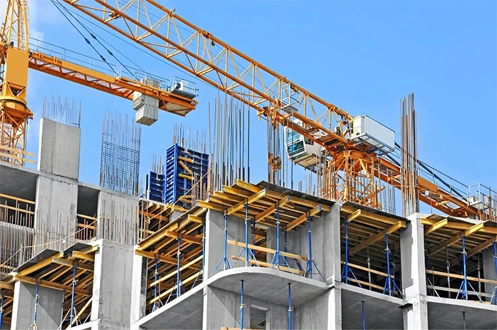 Construction site in Stockton with rebar, scaffolding, and cranes during commercial building development
