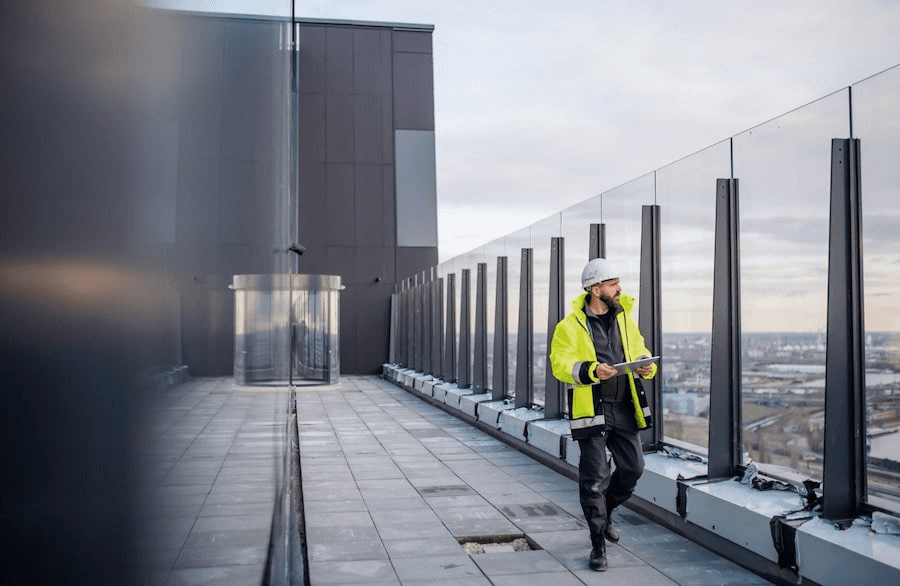 Construction worker inspecting windows of a skycraper