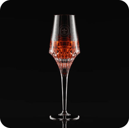 Tall cocktail glass with red liqueur against black background