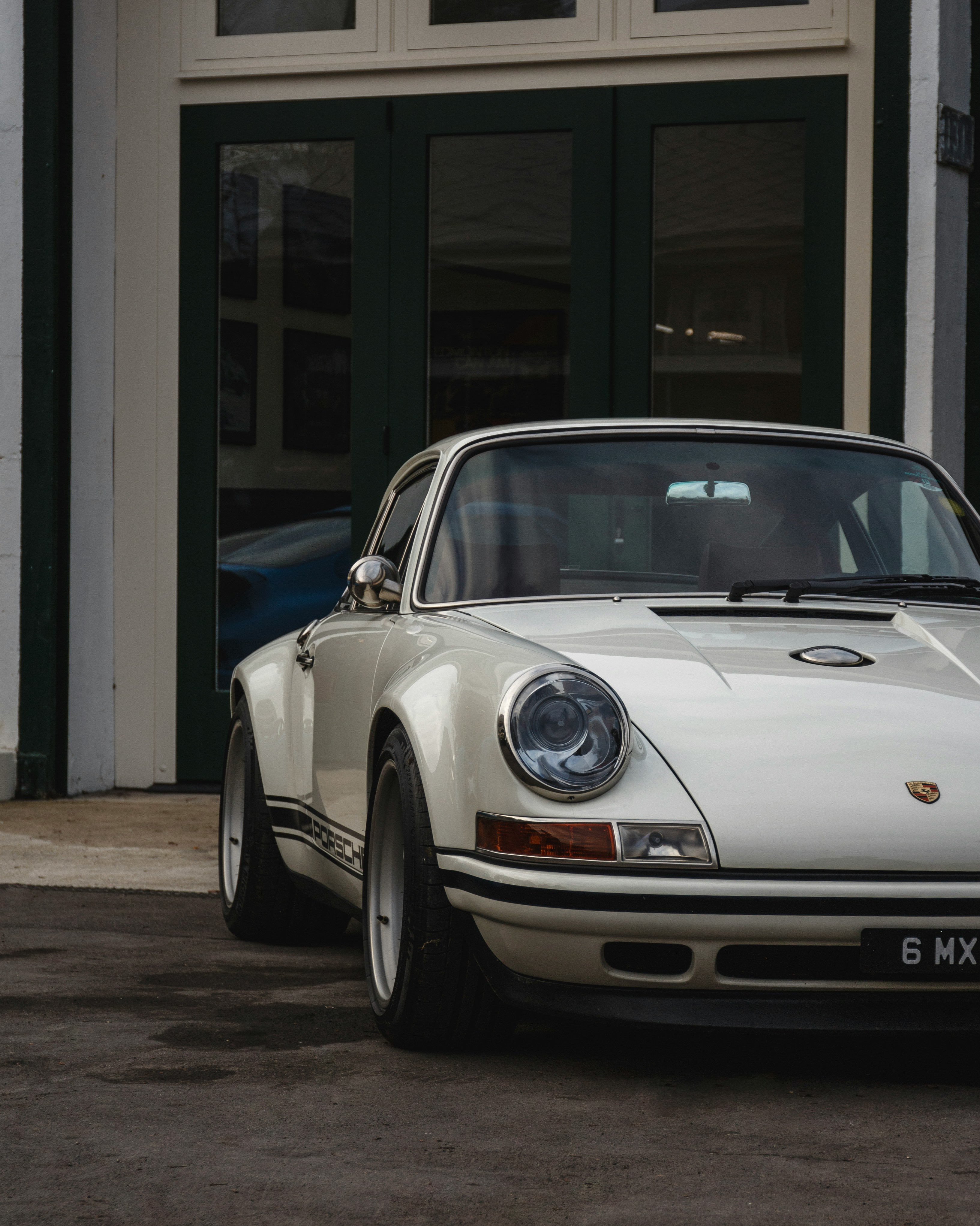 a white car parked in front of a building