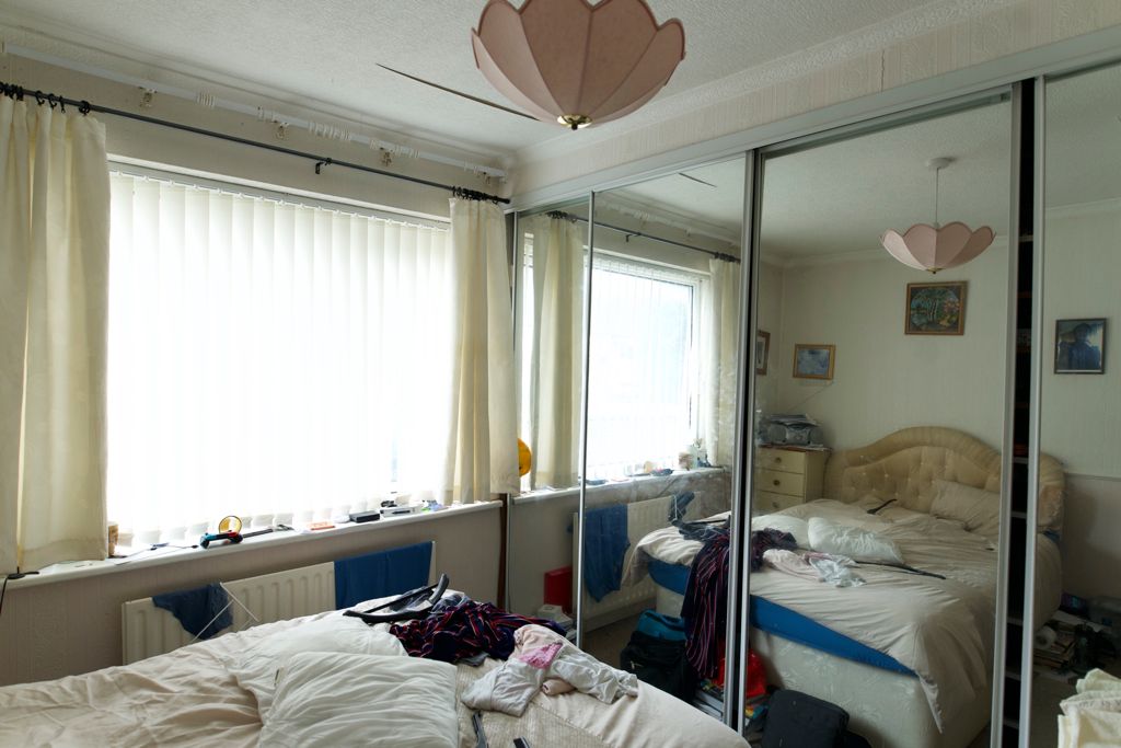 Before: bedroom with neutral tones, basic furniture and minimal colour