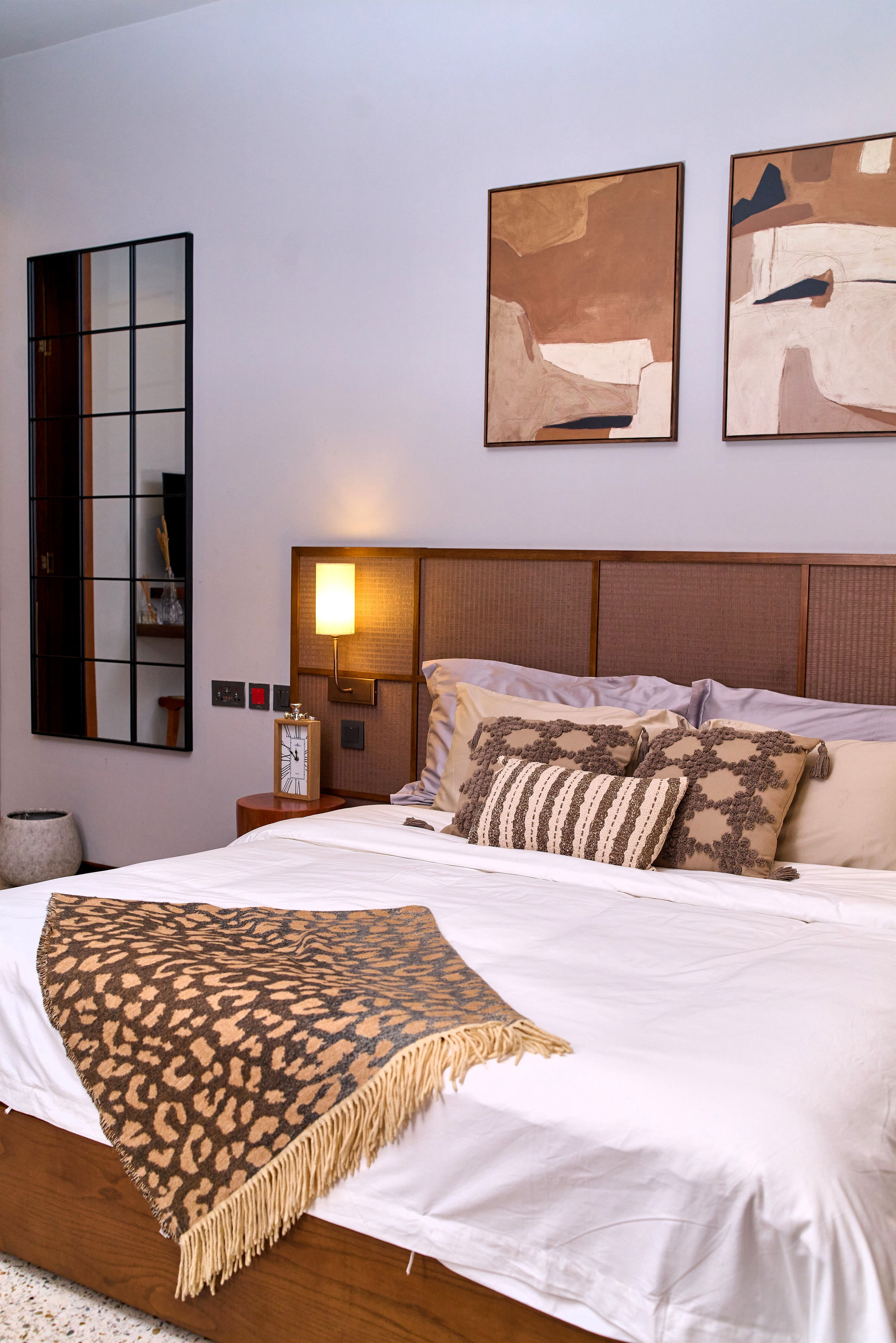 close shot of bed with cushions and throw