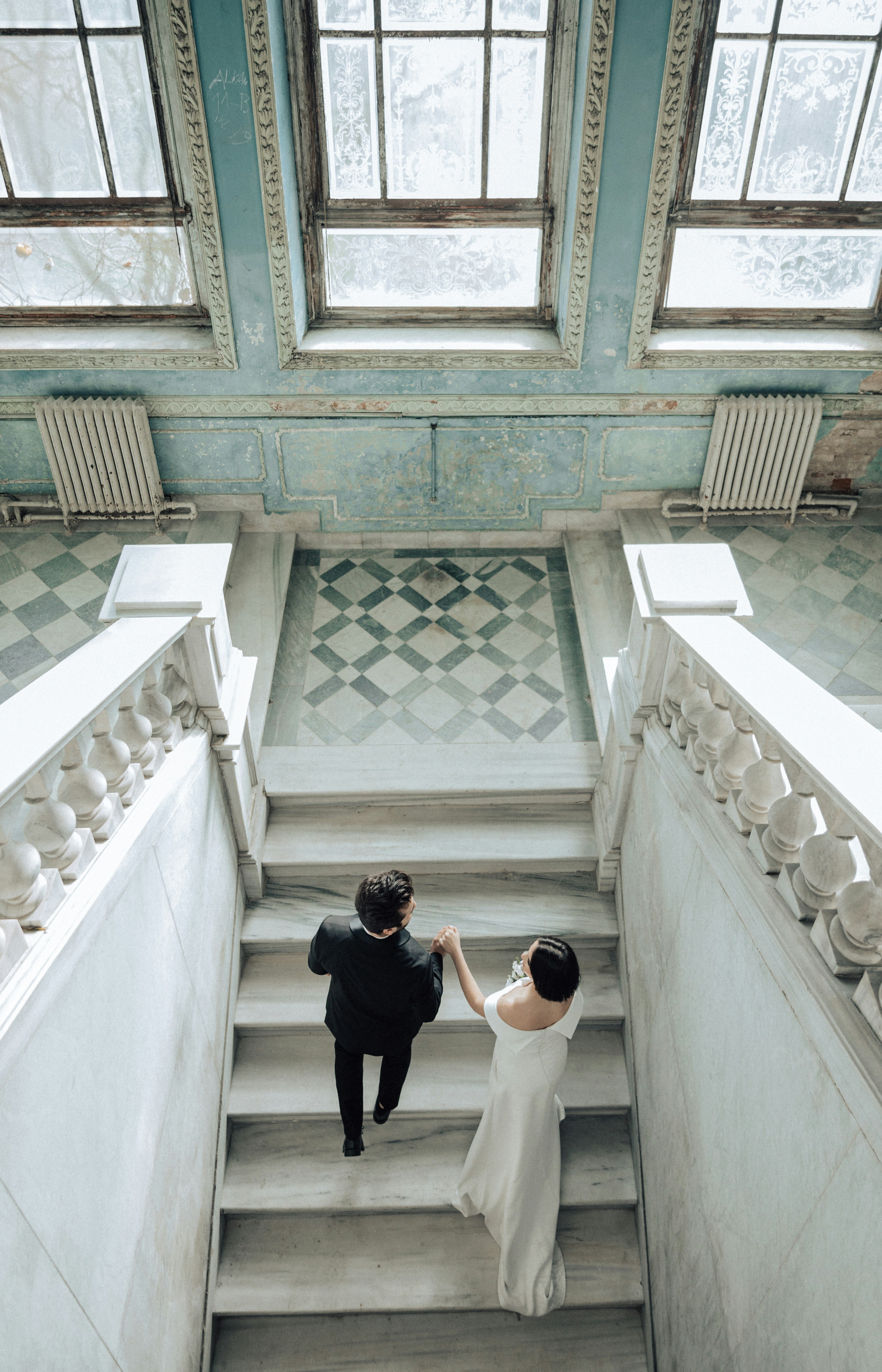 Couple in wedding suit climbing stairs