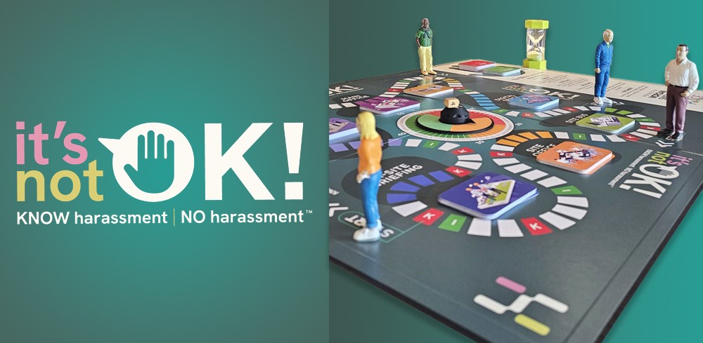 A workplace harassment prevention training board game with miniature figures positioned on a colorful circular game board, alongside the "it's not OK!" logo featuring a stop hand symbol with the tagline "KNOW harassment | NO harassment" on a teal background.