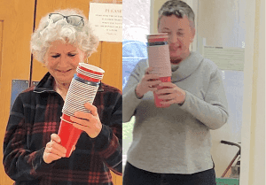Linda Russell and Elaine Lowenberg are in the cups as they prepare for the seder.