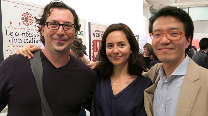two men and a woman in the middle