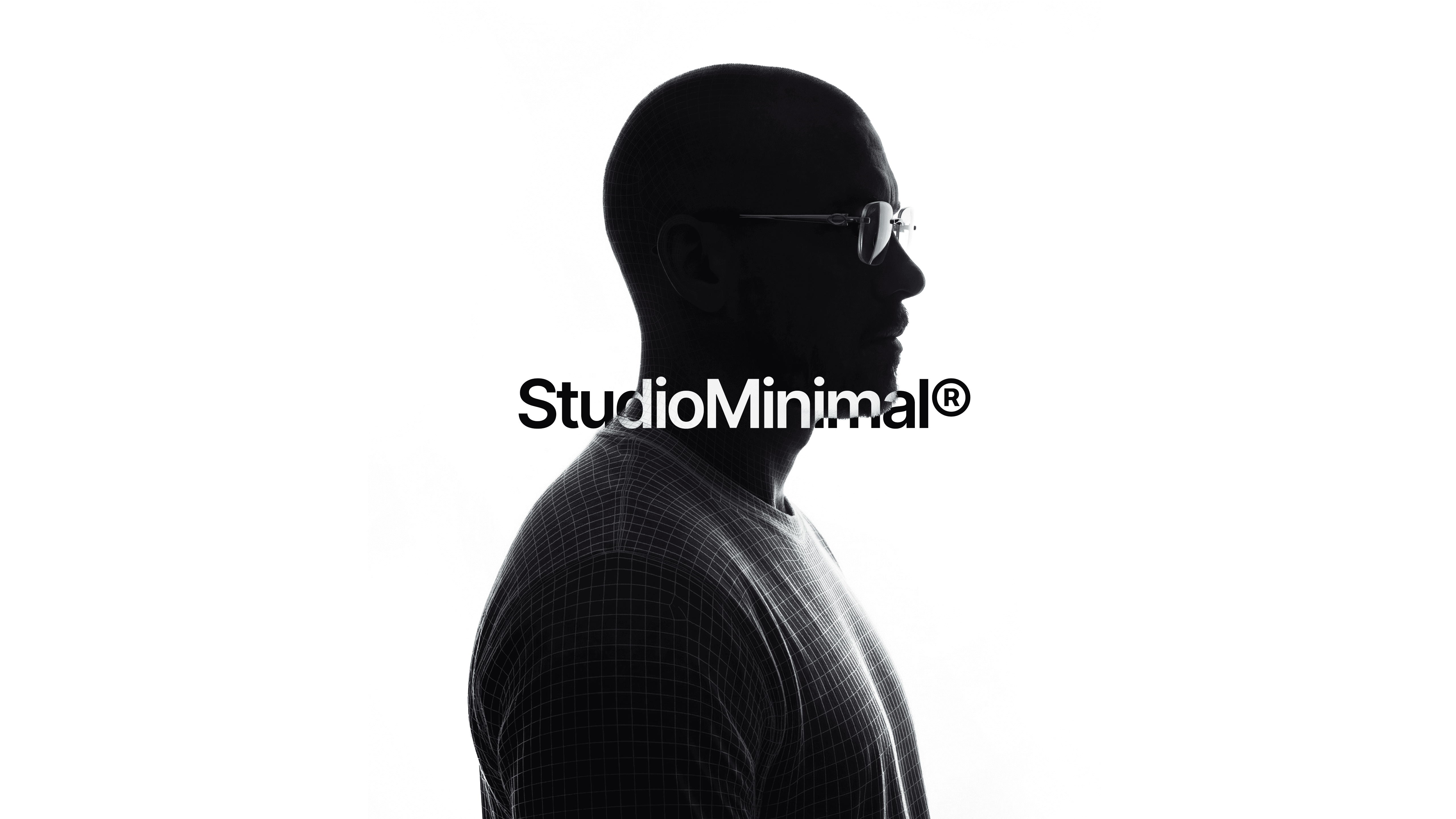 Black and white image of people working at a table with laptops, showing hands gesturing during discussion of digital content displayed on screens, with fabrica® logo in the corner.