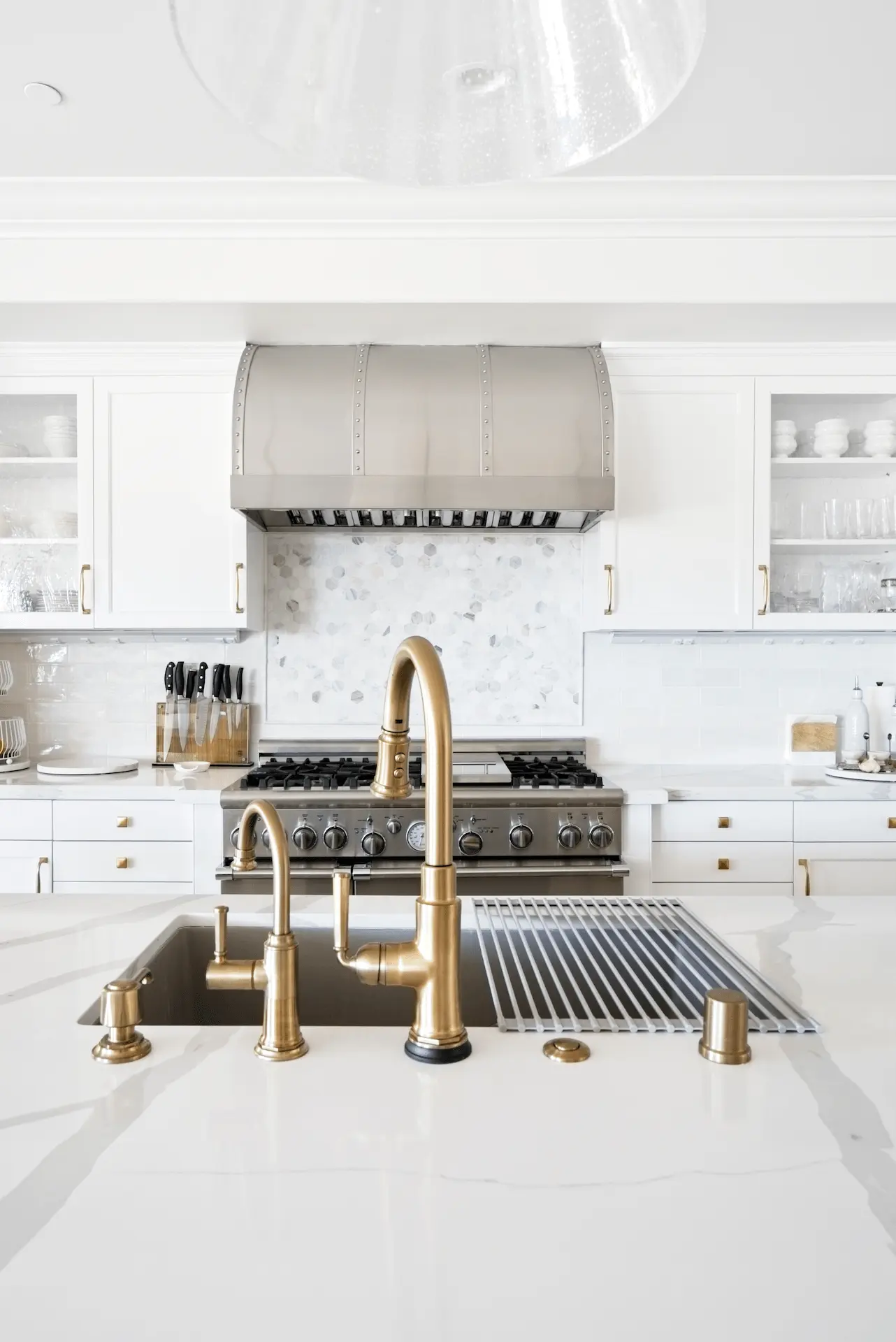 Portrait of the kitchen island with a view of the stove wall, combining functionality with aesthetic appeal in the Ladera Ranch Remodel. Photo by Todd Huge.