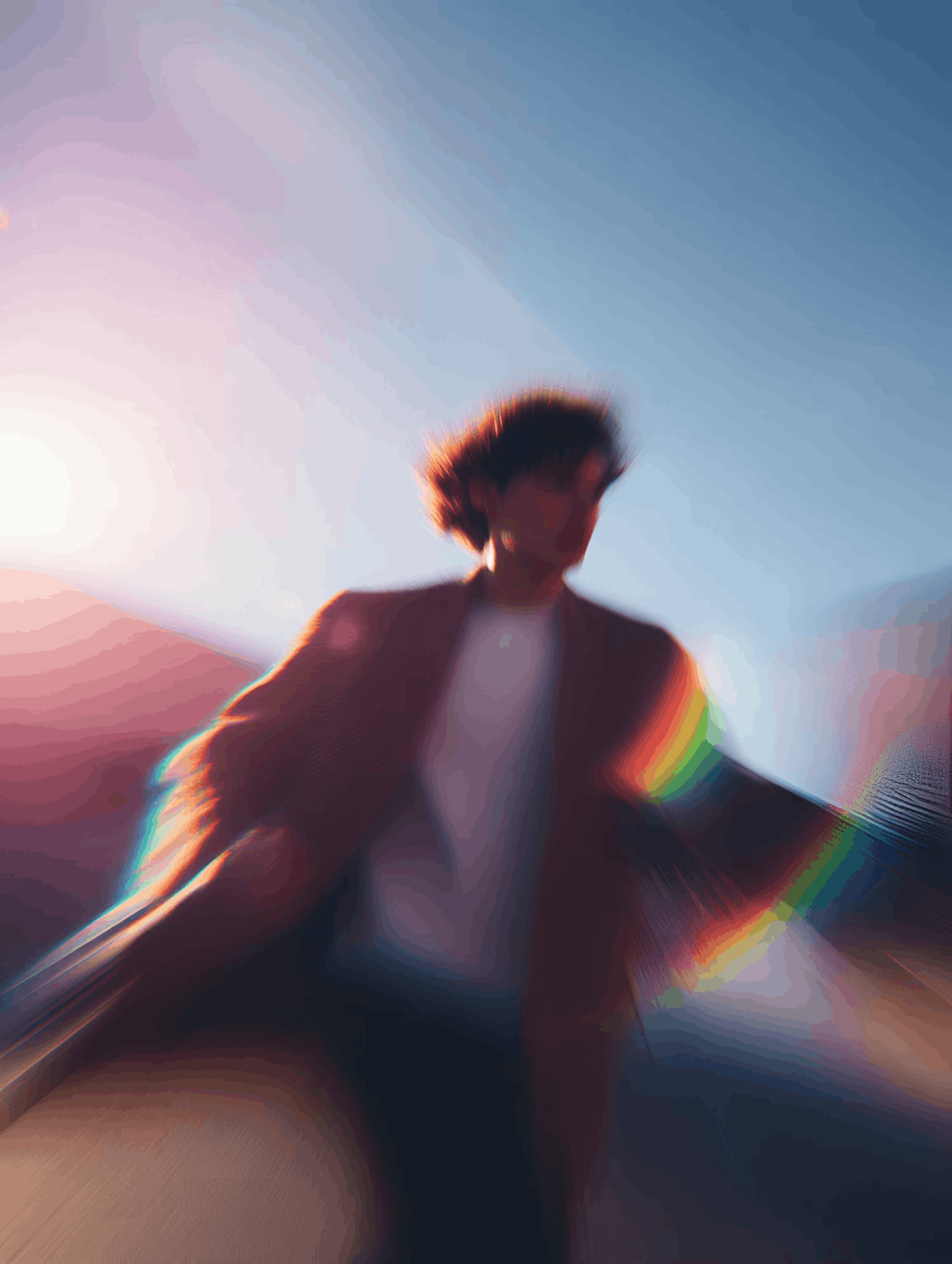 Stylized blur of a person with vibrant light and rainbow streaks.